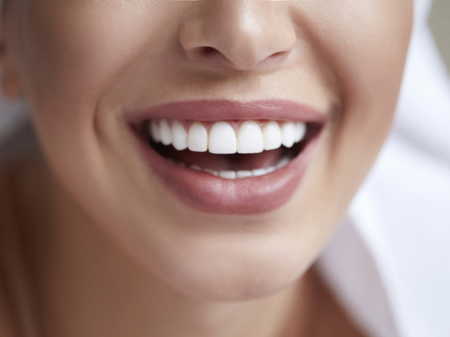 Healthy white smile close up. Beauty woman with perfect smile, lips and teeth. Beautiful Model Girl with perfect skin. Teeth whitening.